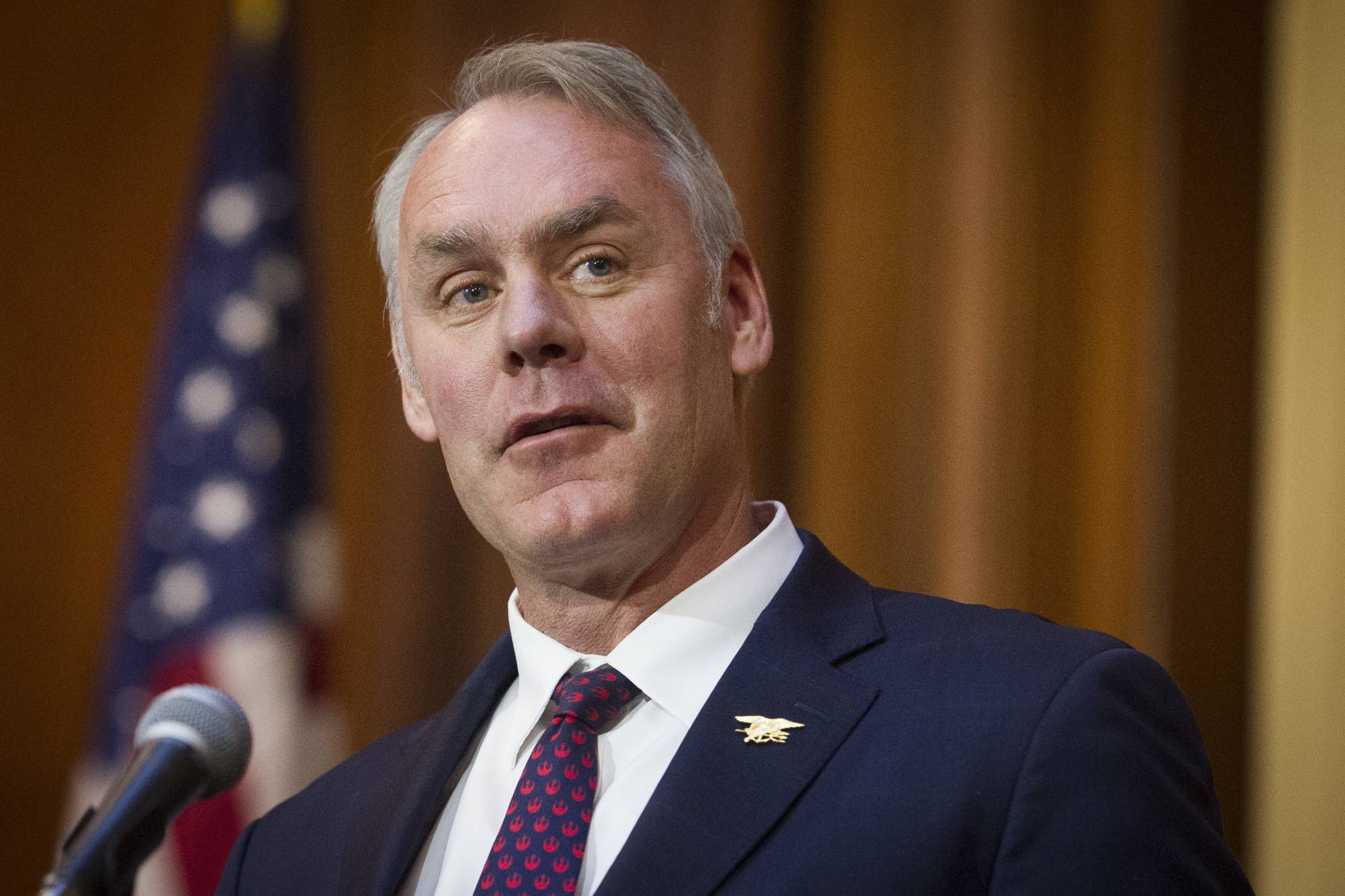 FILE - In this Dec. 11, 2018, file photo, Secretary of the Interior Ryan Zinke speaks after an order withdrawing federal protections for countless waterways and wetland was signed, at EPA headquarters in Washington. Former Interior Secretary Zinke has gotten a job with a private investment company after leaving the Trump administration amid unresolved ethics investigations. North Carolina-based Artillery One said Monday, Jan. 14, 2019, that Zinke has been hired as managing director and will pursue investing opportunities in energy, financial technology and cybersecurity. (AP Photo/Cliff Owen, File)
