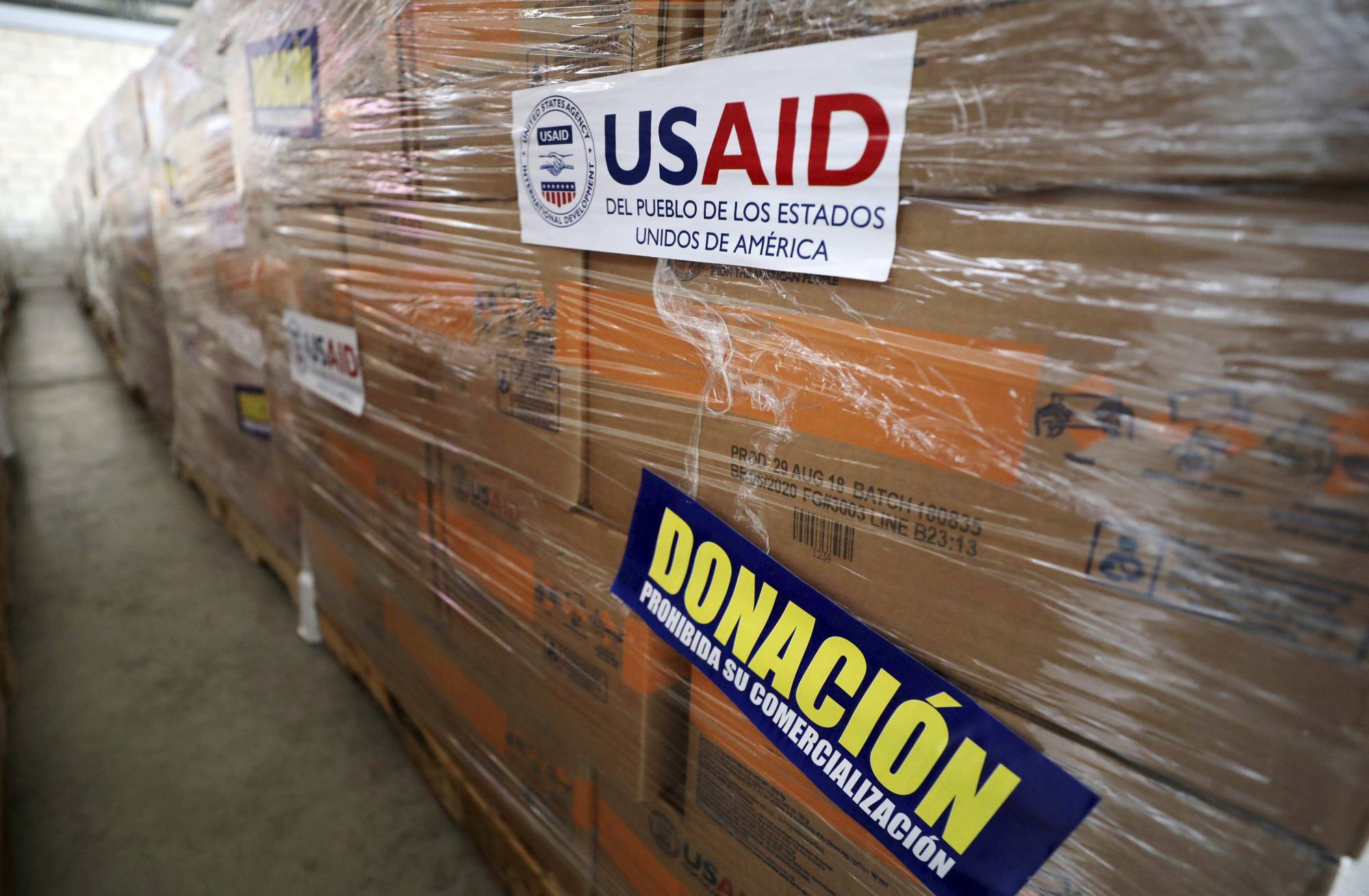 USAID humanitarian aid is stored at a warehouse next to the Tienditas International Bridge on the outskirts of Cucuta, Colombia, on the border with Venezuela, Tuesday, Feb. 19, 2019. The U.S. military airlifted tons of humanitarian aid as part of an effort meant to undermine socialist President Nicolas Maduro and back his rival for the leadership of the South American nation. (AP Photo/Fernando Vergara)