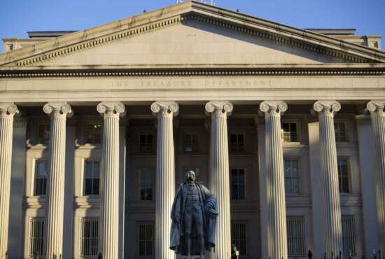 FILE - This June 8, 2017, file photo shows the U.S. Treasury Department building in Washington. The national debt has passed a new milestone, topping $22 trillion for the first time. The Treasury Department's daily statement shows that total outstanding public debt stands at $22.01 trillion. It stood at $19.95 trillion when President Donald Trump took office on Jan. 20, 2017. (AP Photo/Pablo Martinez Monsivais, File)
