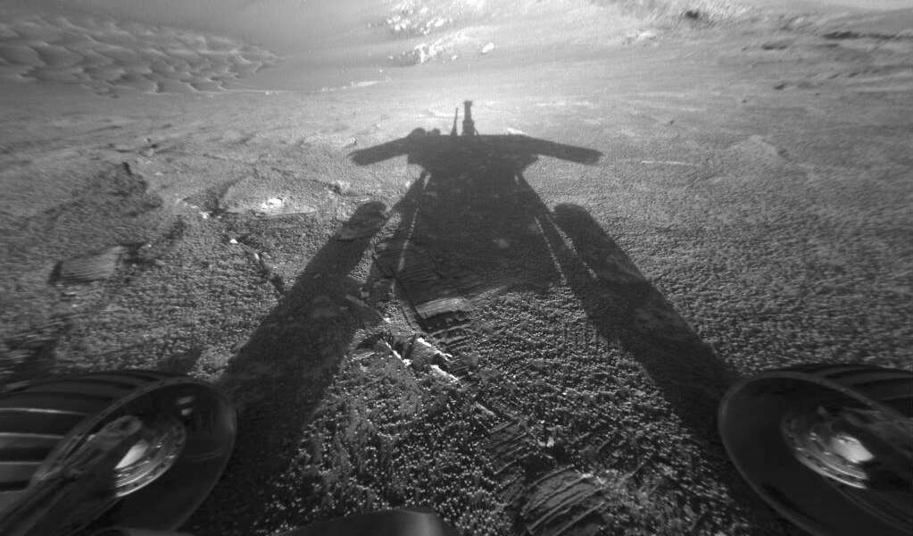 This July 26, 2004 photo made available by NASA shows the shadow of the Mars Exploration Rover Opportunity as it traveled farther into Endurance Crater in the Meridiani Planum region of Mars. (NASA/JPL-Caltech via AP)