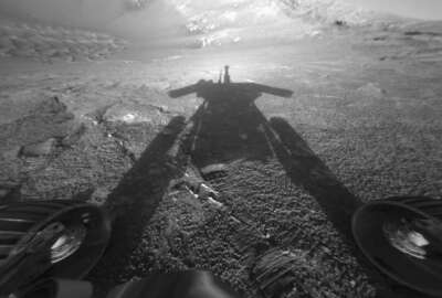 This July 26, 2004 photo made available by NASA shows the shadow of the Mars Exploration Rover Opportunity as it traveled farther into Endurance Crater in the Meridiani Planum region of Mars. (NASA/JPL-Caltech via AP)
