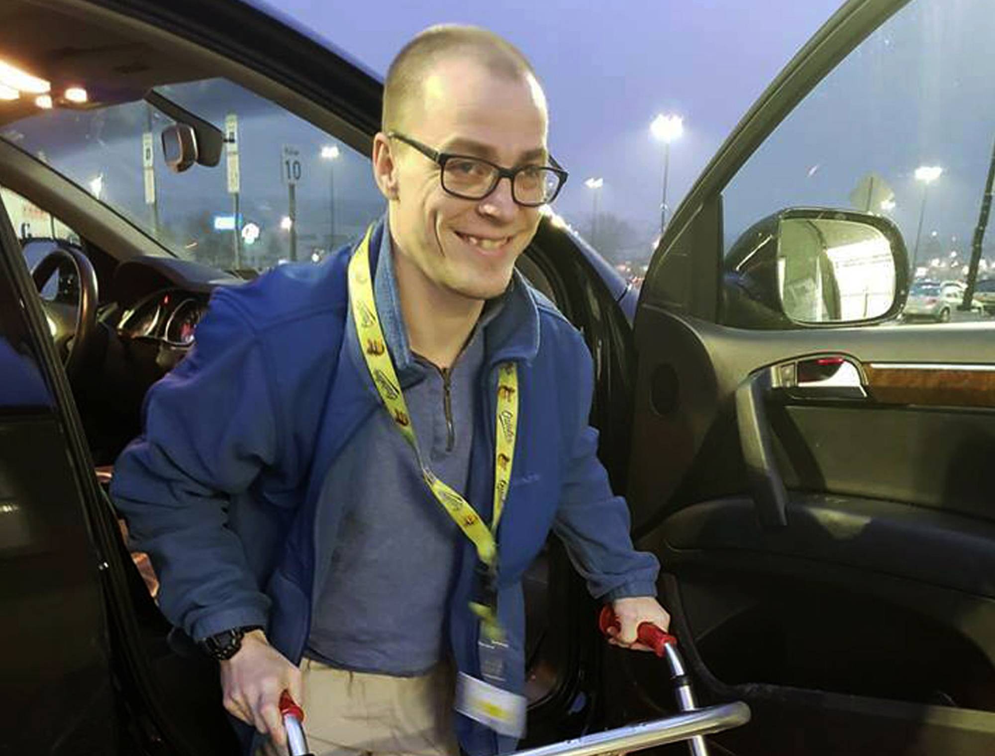 In this Dec. 14, 2018 photo provided by Holly Catlin, Adam Catlin gets out of a car before starting his shift at a Walmart in Selinsgrove, Pa. Catlin, who has cerebral palsy, is afraid he'll be out of work after store officials changed his job description to add tasks that he's physically unable to do. (Holly Catlin via AP)