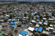 This June 18, 2018, file photo shows an aerial view of the Amelia neighborhood in the municipality of Catano, east of San Juan, Puerto Rico. A long-delayed disaster aid bill that’s a top political priority for some of President Donald Trump’s GOP allies is facing a potentially tricky path as it heads to the Senate floor this week. Although the measure has wide backing from both parties, the White House isn’t pleased with the bill and is particularly opposed to efforts by Democrats to make hurricane relief to Puerto Rico more generous. (AP Photo/Dennis M. Rivera, File)