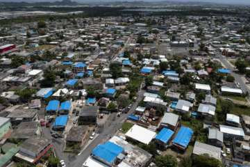 This June 18, 2018, file photo shows an aerial view of the Amelia neighborhood in the municipality of Catano, east of San Juan, Puerto Rico. A long-delayed disaster aid bill that’s a top political priority for some of President Donald Trump’s GOP allies is facing a potentially tricky path as it heads to the Senate floor this week. Although the measure has wide backing from both parties, the White House isn’t pleased with the bill and is particularly opposed to efforts by Democrats to make hurricane relief to Puerto Rico more generous. (AP Photo/Dennis M. Rivera, File)