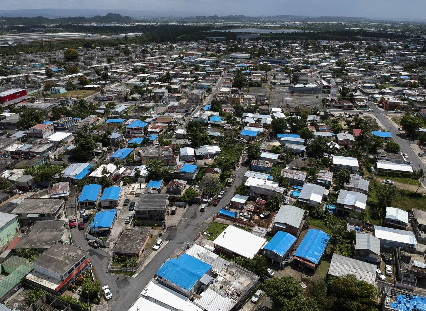 This June 18, 2018, file photo shows an aerial view of the Amelia neighborhood in the municipality of Catano, east of San Juan, Puerto Rico. A long-delayed disaster aid bill that’s a top political priority for some of President Donald Trump’s GOP allies is facing a potentially tricky path as it heads to the Senate floor this week. Although the measure has wide backing from both parties, the White House isn’t pleased with the bill and is particularly opposed to efforts by Democrats to make hurricane relief to Puerto Rico more generous. (AP Photo/Dennis M. Rivera, File)