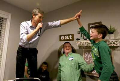 Democratic presidential candidate Beto O'Rourke high-fives Mitchell Murphy, 12, while he speaks at an event at the home of Dubuque County Recorder John Murphy in Dubuque, Iowa on Saturday, March 16, 2019. (Eileen Meslar/Telegraph Herald via AP)