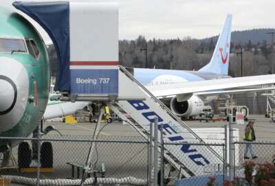 In this Monday, March 11, 2019 file photo, a Boeing 737 MAX 8 airplane being built for TUI Group sits parked in the background at right at Boeing Co.'s Renton Assembly Plant in Renton, Wash. The Transportation Department confirmed that its watchdog agency will examine how the FAA certified the Boeing 737 Max 8 aircraft, the now-grounded plane involved in two fatal accidents within five months. The FAA had stood by the safety of the plane up until last Wednesday, March 13, 2019 despite other countries grounding it.  (AP Photo/Ted S. Warren, File)
