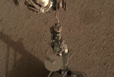 This photo provided by NASA/JPL-Caltech shows an image acquired by NASA's InSight Mars lander using its robotic arm-mounted, Instrument Deployment Camera (IDC). The image was acquired on March 1, 2019, Sol 92 where the local mean solar time for the image exposures was 16:53:31.055 PM. Scientists say NASA's newest Mars lander has started digging into the red planet, but has hit a few snags. (NASA/JPL-Caltech via AP)