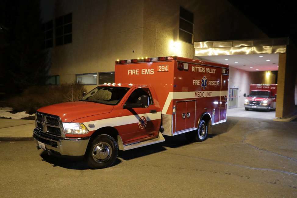 A Kittitas Valley Fire &amp; Rescue ambulance carries the body of a Kittitas County Sheriff's deputy away from Kittitas Valley Healthcare Hospital, in the early morning hours of Wednesday, March 20, 2019, in Ellensburg, Wash. A Kittitas County Sheriff's deputy was killed and a police officer was injured after an exchange of gunfire during an attempted traffic stop. (AP Photo/Ted S. Warren)