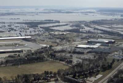 This March 17, 2019 photo released by the U.S. Air Force shows an aerial view of Offutt Air Force Base and the surrounding areas affected by flood waters in Neb. Surging unexpectedly strong and up to 7 feet high, the Missouri River floodwaters that poured on to much the Nebraska air base that houses the U.S. Strategic Command overwhelmed the frantic sandbagging by troops and their scramble to save sensitive equipment, munitions and aircraft. (Tech. Sgt. Rachelle Blake/The U.S. Air Force via AP)