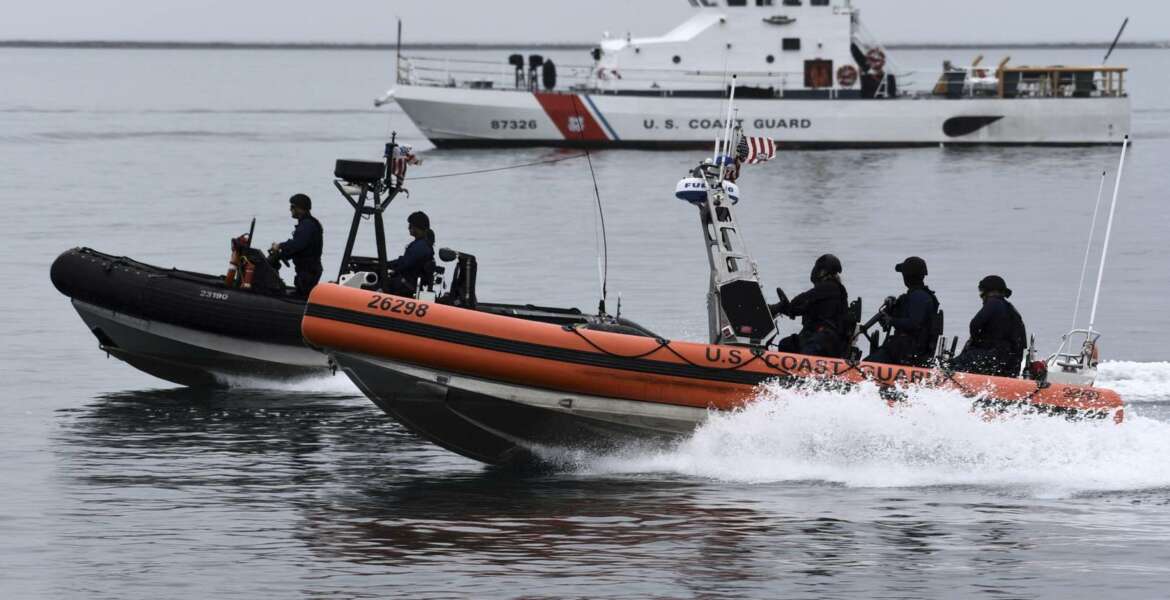 U.S. Coast Guard Maritime Security Response Team-West crew members conduct a tactical demonstration in the Port of Los Angeles, Thursday, March 21, 2019. Strapped with an aging fleet, the U.S. Coast Guard is about to award a contract for a much-needed new icebreaker to help compete against Russia and China for a presence in the Arctic, but the service needs more funding for operations and infrastructure, its commandant said Thursday. (Seaman Ryan Estrada/U.S. Coast Guard via AP)