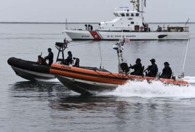 U.S. Coast Guard Maritime Security Response Team-West crew members conduct a tactical demonstration in the Port of Los Angeles, Thursday, March 21, 2019. Strapped with an aging fleet, the U.S. Coast Guard is about to award a contract for a much-needed new icebreaker to help compete against Russia and China for a presence in the Arctic, but the service needs more funding for operations and infrastructure, its commandant said Thursday. (Seaman Ryan Estrada/U.S. Coast Guard via AP)