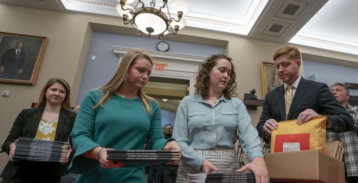 Office of Management and Budget staff delivers President Donald Trump's 2020 budget to the House Budget Committee on Capitol Hill in Washington, Monday, March 11, 2019. Trump's new budget calls for billions more for his border wall, with steep cuts in domestic programs but increases for military spending. (AP Photo/J. Scott Applewhite)