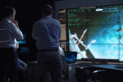 People working in mission control center