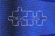 matching pieces of puzzle with text DevOps, concept of software development and operations