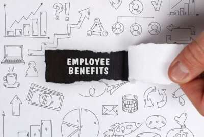 Business, Technology, Internet and network concept. Young businessman shows the word: Employee benefits