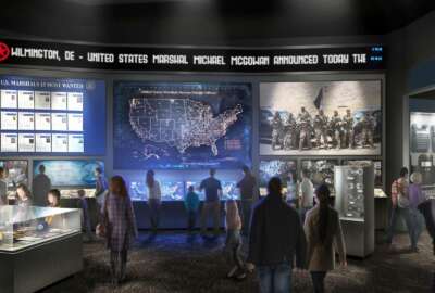 This artist's rendering provided by the United States Marshals Museum Friday, April 26, 2019, depicts a proposed exhibit showing the work U.S. Marshals do today at a future museum in Fort Smith, Arkansas. The $50 million museum dedicated to the U.S. Marshals is about $15 million under-funded, and the museum's foundation recently announced a crowdfunding effort to raise money. Though the building will be dedicated in September as originally planned, the museum's opening has been pushed back to sometime next year. (United States Marshals Museum via AP)