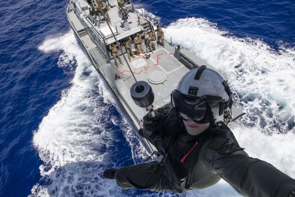 SANTA RITA, Guam (May 8, 2019) Naval Air Crewman (Helicopter) 2nd Class Nathan Swartz, from Elmhurst, Ill., is lowered to a Mark VI patrol boat assigned to Coastal Riverine Squadron (CRS) 2, from an MH-60S Sea Hawk helicopter assigned to the "Island Knights" of Helicopter Sea Combat Squadron (HSC) 25 during a casualty evacuation training evolution between CRS-2 and HSC-25. CRS-2 is assigned to Costal Riverine Group 1, Det. Guam and is capable of conducting maritime security operations across the full spectrum of naval, joint and combined operations. HSC-25 provides a multi-mission rotary wing capability for units in the U.S. 7th Fleet area of operations and maintains a Guam-based 24-hour search-and-rescue and medical evacuation capability, directly supporting U.S. Coast Guard and Joint Region Marianas. (U.S. Navy photo by Mass Communication Specialist 2nd Class Kelsey L. Adams/Released)190508-N-RM689-1374