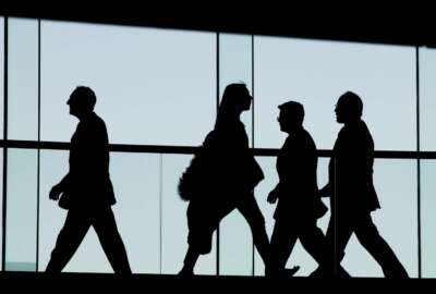 FILE - In this Tuesday, Jan. 5, 2016, file photo, people walk at the National Constitution Center in Philadelphia. Americans generally do not have enough saved for retirement and Congress is considering a number of measures to address that. (AP Photo/Matt Rourk, File)