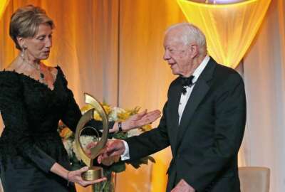 FILE - In this Jan. 27, 2017, file photo, former President Jimmy Carter, right, accepts the O'Connor Justice Prize from former U.S. Ambassador to Finland Barbara Barrett, left, at The Sandra Day O'Connor College of Law at Arizona State University Justice Prize Dinner in Phoenix. President Donald Trump has nominated Barrett to be the next secretary of the Air Force. (AP Photo/Ross D. Franklin, File)
