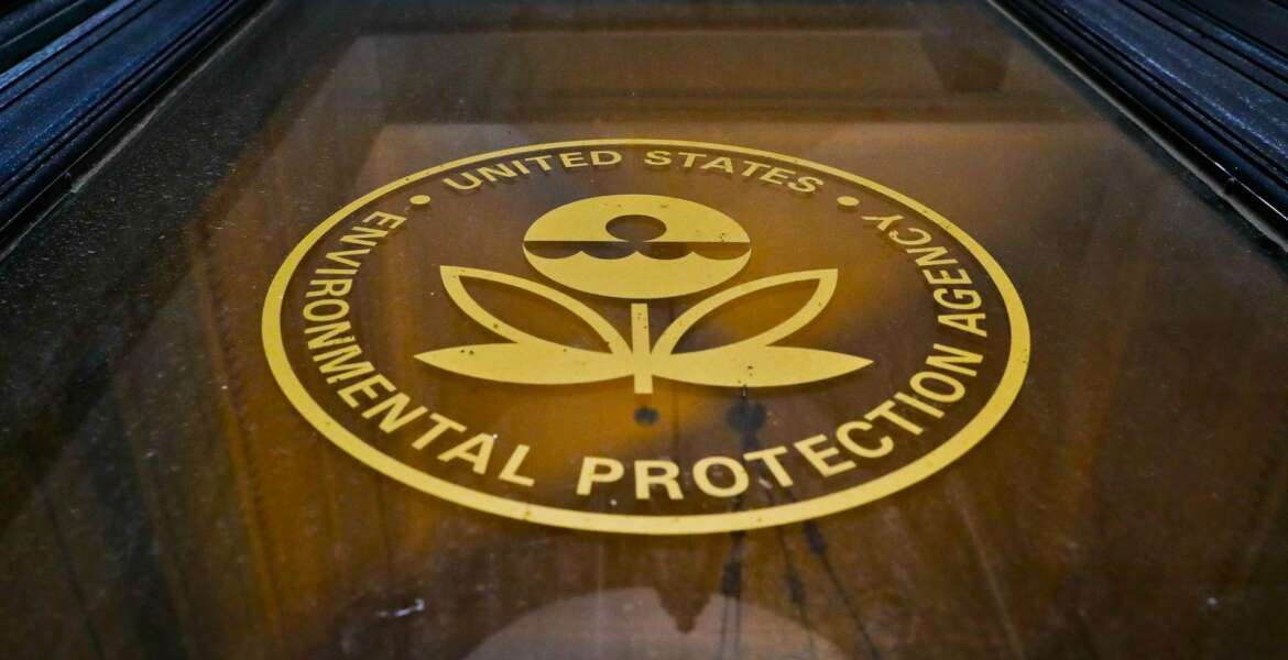 FILE - In this Sept. 21, 2017, file photo, a sign on a door of the Environmental Protection Agency in Washington. Long-running research projects credited with pivotal discoveries about the harm that pesticides, air pollution and other hazards pose to children are in jeopardy or shutting down because the Environmental Protection Agency will not commit to their continued funding, researchers say.  (AP Photo/Pablo Martinez Monsivais, File)