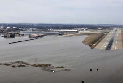 FILE - This March 17, 2019, file photo provided by the U.S. Air Force shows an aerial view of Offutt Air Force Base and the surrounding areas affected by floodwaters in Nebraska. The Air Force is raising its cost estimate to $420 million to repair and replace structures damaged at the Nebraska base following severe flooding that inundated buildings with water. (Tech. Sgt. Rachelle Blake/U.S. Air Force via AP, File)