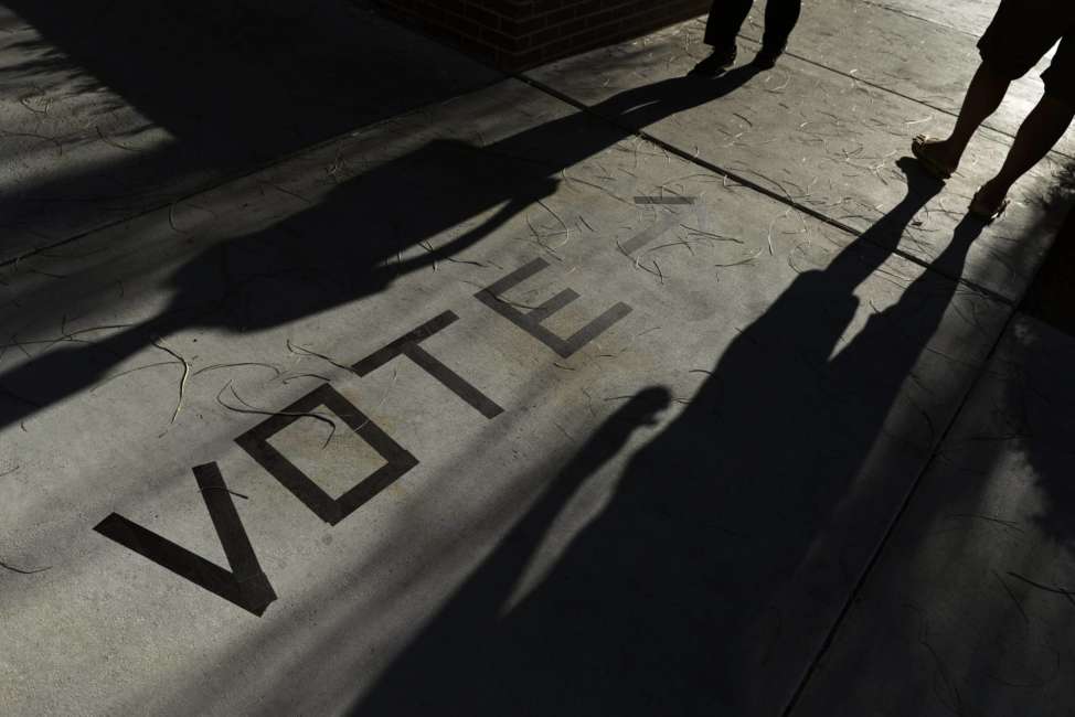 FILE - In this Nov. 6, 2018 file photo, voters head to the polls at the Enterprise Library,  in Las Vegas. A new survey finds that more than 120 million Americans cast ballots in the 2018 midterm elections, with turnout surging in some states to that of a typical presidential year. The 2018 Election Administration and Voting Survey was released Thursday, June 27, 2019, by the U.S. Election Assistance Commission.  (AP Photo/Joe Buglewicz, File)