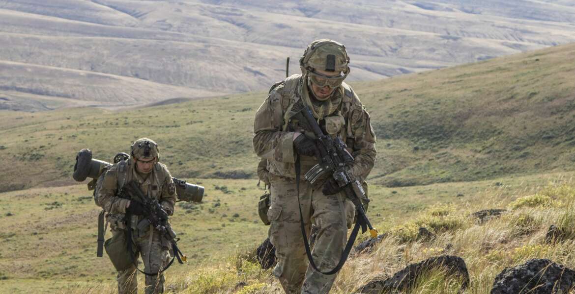 Pfc. Michael Roberts and Pvt. Nicholas Brown, cavalry scouts for Charlie Troop, 1st Squadron, 82nd Cavalry Regiment navigate rough eastern Washington terrain on foot while conducting dismounted zone reconnaissance training at the Yakima Training Center in Yakima, Wash., June 25, 2019. The training is part of a large-scale exercise known as eXportable Combat Training Capability (XCTC), which focuses on improving individual and team skillsets, decision making, equipment familiarization, and deployment readiness. (U.S. Army Photo by Sgt. Jennifer Lena, 115th Mobile Public Affairs Detachment)