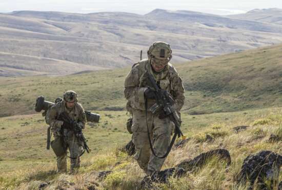Pfc. Michael Roberts and Pvt. Nicholas Brown, cavalry scouts for Charlie Troop, 1st Squadron, 82nd Cavalry Regiment navigate rough eastern Washington terrain on foot while conducting dismounted zone reconnaissance training at the Yakima Training Center in Yakima, Wash., June 25, 2019. The training is part of a large-scale exercise known as eXportable Combat Training Capability (XCTC), which focuses on improving individual and team skillsets, decision making, equipment familiarization, and deployment readiness. (U.S. Army Photo by Sgt. Jennifer Lena, 115th Mobile Public Affairs Detachment)