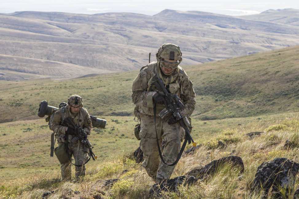 Pfc. Michael Roberts and Pvt. Nicholas Brown, cavalry scouts for Charlie Troop, 1st Squadron, 82nd Cavalry Regiment navigate rough eastern Washington terrain on foot while conducting dismounted zone reconnaissance training at the Yakima Training Center in Yakima, Wash., June 25, 2019. The training is part of a large-scale exercise known as eXportable Combat Training Capability (XCTC), which focuses on improving individual and team skillsets, decision making, equipment familiarization, and deployment readiness. (U.S. Army Photo by Sgt. Jennifer Lena, 115th Mobile Public Affairs Detachment)