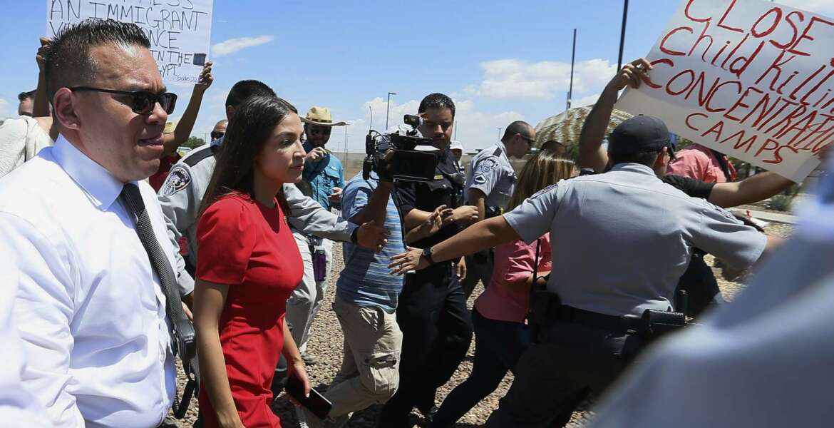 U.S. Rep. Alexandria Ocasio-Cortez, D-New York, is escorted back to her vehicle after she speaks at the Border Patrol station in Clint, Texas, about what she saw at area border facilities Monday, July 1, 2019. (Briana Sanchez/El Paso Times via AP)