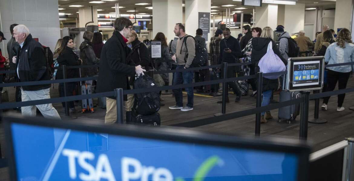 FILE - In this Jan. 11, 2019, file photo, passengers wait in line at a Transportation Security Administration checkpoint at the Philadelphia International Airport in Philadelphia. The chief of the TSA said Monday, July 1, that travelers should see only a slight increase in checkpoint wait times over the four-day July 4 holiday weekend despite the diversion of about 350 employees including screeners to the U.S.-Mexico border. (AP Photo/Matt Rourke, File)