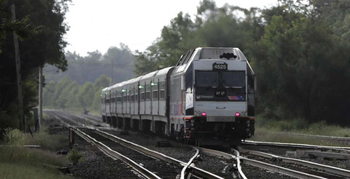 FILE- This Aug. 3, 2018, file photo shows a New Jersey Transit train leaving the Bound Brook Station in Bound Brook, N.J. Federal railway officials say the railroad industry has installed safety technology on nearly 90 percent of tracks where it is required, but “significant work” is needed to ensure the technology is completely installed by a December 2020 deadline. (AP Photo/Julio Cortez, File)
