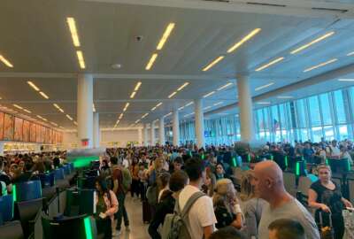 In this photo provided by Twitter user Brenna but in Leo Season, travelers stand in long lines to clear customs at John F. Kennedy International Airport, Friday, Aug. 16, 2019, in New York, due to a temporary computer outage that affected U.S. Customs and Border Protection. (Brenna but in Leo Season via AP)