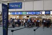 FILE- In this Thursday, June 21, 2018 photo, air passengers heading to their departure gates enter TSA pre-check before going through security screening at Orlando International Airport, in Orlando, Fla. Investigators were unable to corroborate specific allegations that a Transportation Security Administration supervisor instructed air marshals to racially discriminate against passengers at Florida's busiest airport. But investigators for the Department of Homeland Security's Office of Inspector General uncovered other concerns about racial profiling of passengers by other TSA supervisors at Orlando International Airport, according to a report sent to lawmakers last week. (AP Photo/John Raoux)