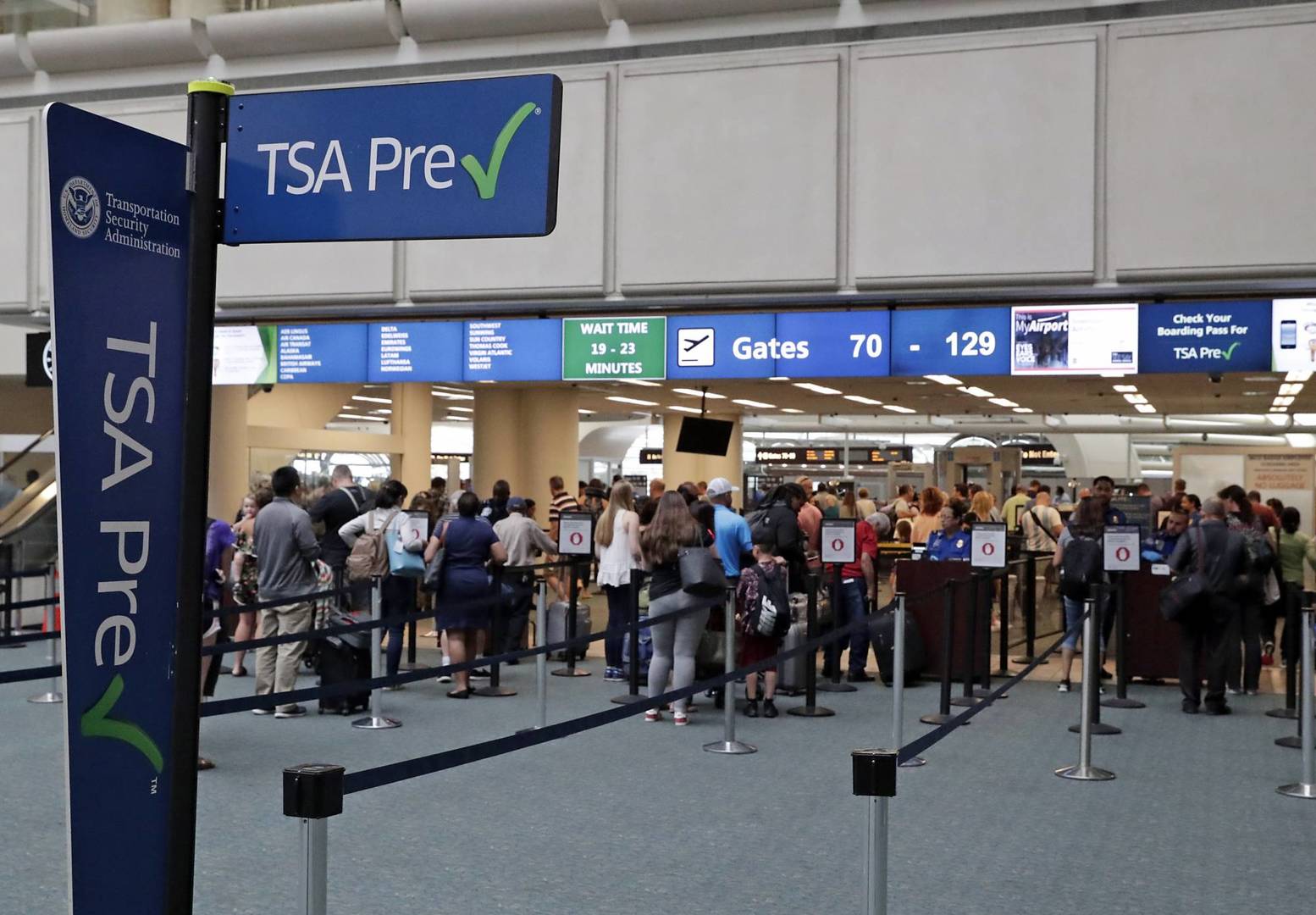 FILE- In this Thursday, June 21, 2018 photo, air passengers heading to their departure gates enter TSA pre-check before going through security screening at Orlando International Airport, in Orlando, Fla. Investigators were unable to corroborate specific allegations that a Transportation Security Administration supervisor instructed air marshals to racially discriminate against passengers at Florida's busiest airport. But investigators for the Department of Homeland Security's Office of Inspector General uncovered other concerns about racial profiling of passengers by other TSA supervisors at Orlando International Airport, according to a report sent to lawmakers last week. (AP Photo/John Raoux)