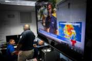 Emergency Center personnel stand next to a tv screen showing a meteorological image of the tropical storm Dorian, as they await its arrival, in Ceiba, Puerto Rico, Wednesday, Aug. 28, 2019. Puerto Rico is facing its first major test of emergency preparedness since the 2017 devastation of Hurricane Maria as Tropical Storm Dorian nears the U.S. territory at near-hurricane force.  (AP Photo/Ramon Espinosa)