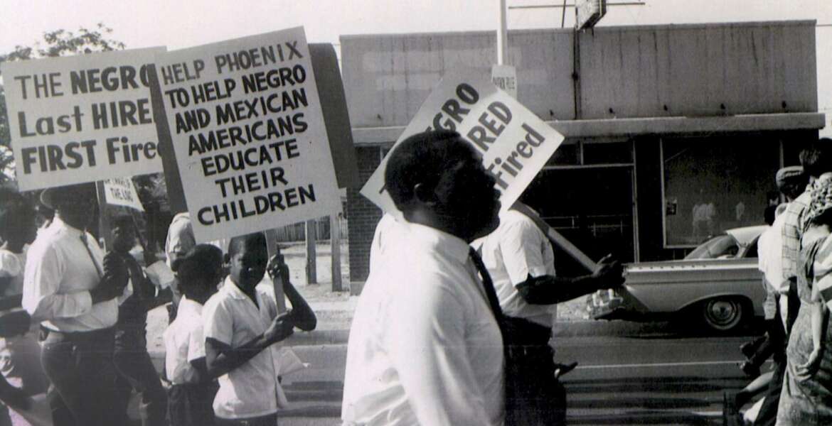In this 1962 photo, Civil Rights leader Lincoln Ragsdale and supporters march on the Arizona state capitol for the desegregation of public places with the public accommodation bill prior to the Civil Rights Act of 1964. Phoenix’s past segregation has been in focus after last month’s national outrage over a videotaped encounter of police pointing guns and cursing at a black family.  (Lincoln Ragsdale Jr/Matthew Whitaker Photographs, University Archives, Arizona State University Library via AP)