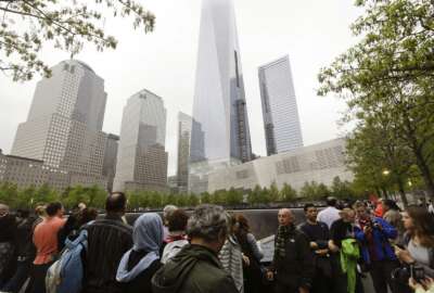 FILE- In this May 15, 2015 file photo, visitors gather near the pools at the 9/11 Memorial in New York. As they have done 17 times before, a crowd of victims' relatives is expected at the site on Wednesday, Sept. 11, 2019 to observe the anniversary the deadliest terror attack on American soil. (AP Photo/Frank Franklin II)
