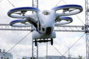 NEC Corp.'s machine with propellers hovers at the company's facility in Abiko near Tokyo, Monday, Aug. 5, 2019. The Japanese electronics maker showed a "flying car," a large drone-like machine with four propellers that hovered steadily for about a minute. (AP Photo/Koji Sasahara)