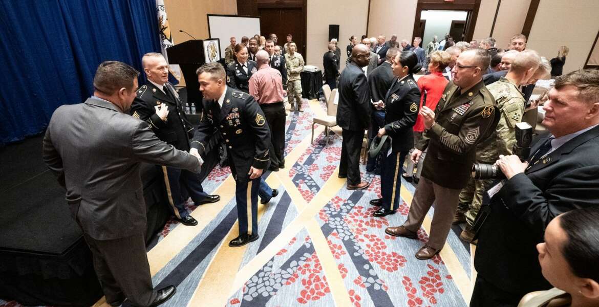 Army Command Sgt. Maj. John W. Troxell, Senior Enlisted Advisor to the chairman of the Joint Chiefs of Staff, and Retired U.S. Army Master Sgt. Leroy A. Petry, Medal of Honor Recipient, pose with service members after an Association of the United States Army breakfast for the Fifth, Sixth, and Seventh regions in Washington, D.C., on Oct. 16, 2019. Troxell stressed the importance of a fit and lethal force to combat growing threats around the globe. (DoD Photo by U.S. Army Sgt. James K. McCann)