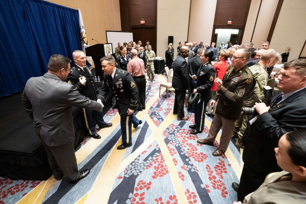 Army Command Sgt. Maj. John W. Troxell, Senior Enlisted Advisor to the chairman of the Joint Chiefs of Staff, and Retired U.S. Army Master Sgt. Leroy A. Petry, Medal of Honor Recipient, pose with service members after an Association of the United States Army breakfast for the Fifth, Sixth, and Seventh regions in Washington, D.C., on Oct. 16, 2019. Troxell stressed the importance of a fit and lethal force to combat growing threats around the globe. (DoD Photo by U.S. Army Sgt. James K. McCann)