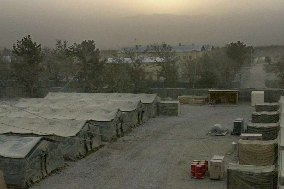 SUNSET BEHIND ROW OF ARMY TENTS, BAGRAM AIR BASE, AFGHANISTAN, PHOTO