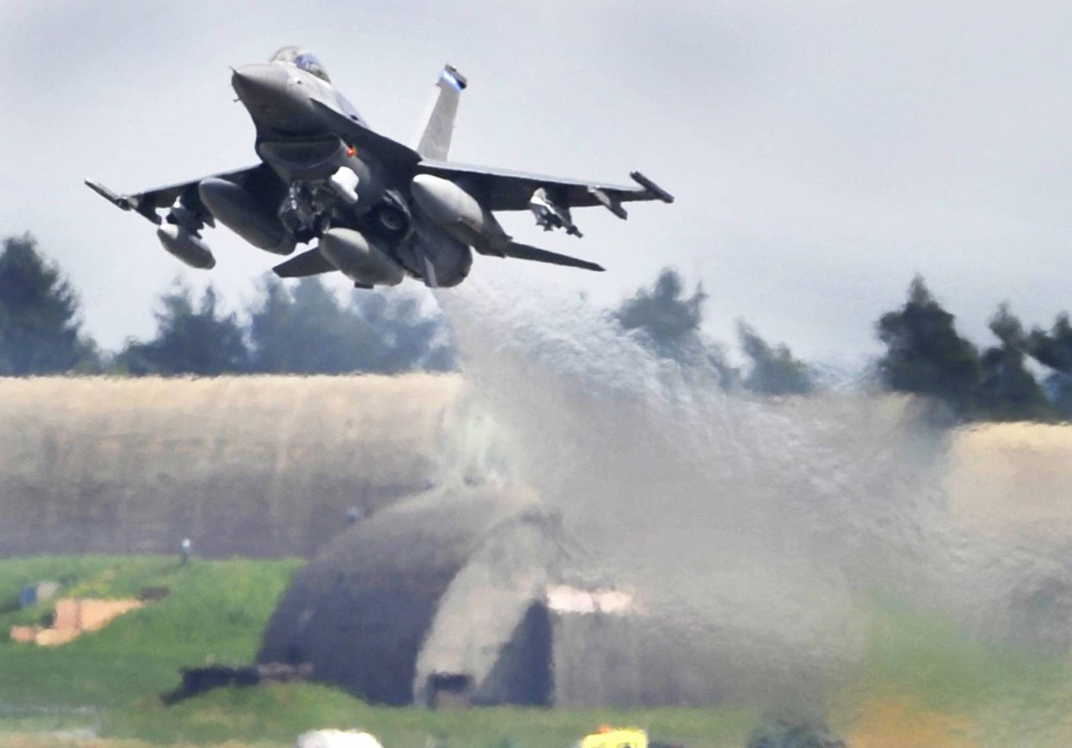 FILE - In this April 27, 2010 file photo an F-16 airplane lifts off at the US military Airport in Spangdahlem, Germany. The U.S. military says an F-16 fighter jet has crashed in western Germany but the pilot ejected to safety. Police said the plane came down in the Zemmer area, between the city of Trier and the U.S. Air Force's Spangdahlem Air Base. (Boris Roessler/dpa via AP, file)