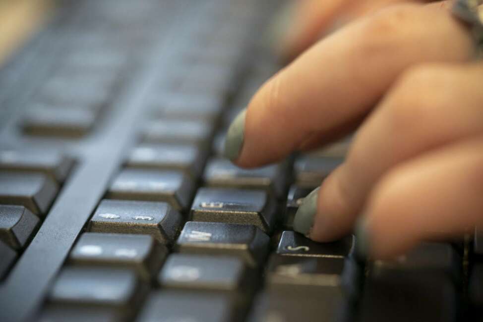 In this Tuesday, Oct. 8, 2019, photo a woman types on a keyboard in New York. Cybersecurity researchers say a coordinated cyberespionage campaign has targeted U.N. relief agencies, the International Red Cross and other non-governmental organizations groups for the past 10 months. The California cybersecurity outfit Lookout says the campaign, which uses phishing to harvest passwords from mobile phones and computers, is still active. (AP Photo/Jenny Kane)