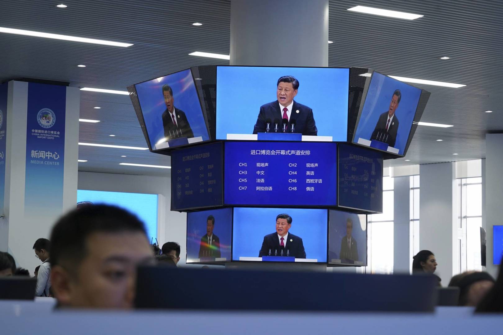Chinese President Xi Jinping is seen on a live broadcast speaking at the media center during the opening of the China International Import Expo in Shanghai, Tuesday, Nov. 5, 2019. Xi promised Tuesday to open China wider to imports and foreign investment at the start of a high-profile trade fair meant to rebrand the country as a global customer and warned against trade protectionism. (AP Photo/Dake Kang)