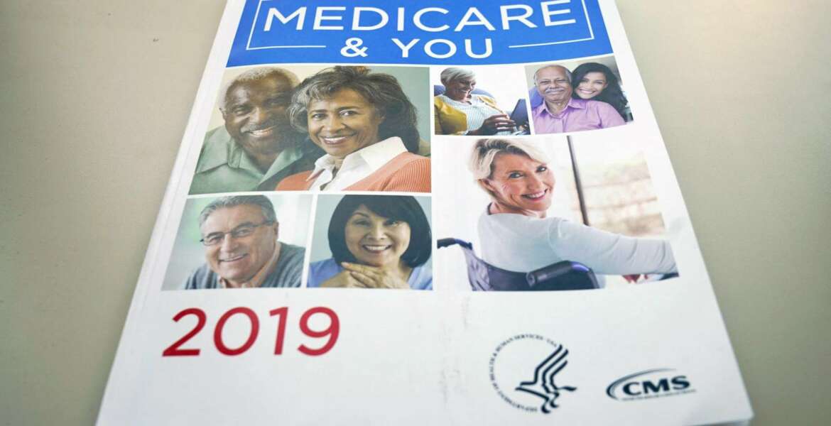 FILE - In this Nov. 8, 2018, file photo, the U.S. Medicare Handbook is photographed, in Washington. A new study finds that more than half of seriously ill Medicare enrollees _ 53% _ struggle to pay their medical bills. Prescription drugs are the leading problem. The researchers who wrote Monday’s report in the journal Health Affairs were surprised by their findings, since Medicare is considered relatively good coverage.  (AP Photo/Pablo Martinez Monsivais, File)