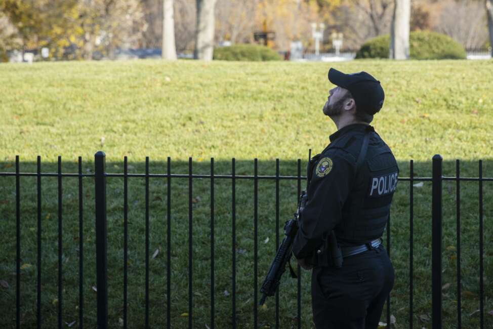 A uniformed Secret Service Officer patrols the White House grounds during a lockdown due to an airspace violation, Tuesday, Nov. 26, 2019, in Washington. (AP Photo/ Evan Vucci)