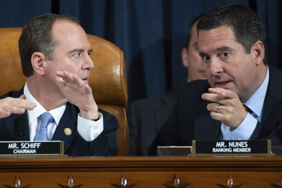 House Intelligence Committee Chairman Rep. Adam Schiff, D-Calif., left, talks with ranking member Rep. Devin Nunes, R-Calif., during a hearing of the House Intelligence Committee on Capitol Hill in Washington, Wednesday, Nov. 13, 2019, during the first public impeachment hearing of President Donald Trump's efforts to tie U.S. aid for Ukraine to investigations of his political opponents. (Saul Loeb/Pool Photo via AP)