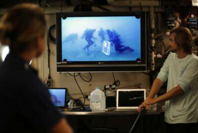 Researchers and crew aboard the NOAA Ship Nancy Foster watch footage of divers working at Gray's Reef, about 20 miles off the coast of Georgia on Wednesday, Aug. 4, 2019. (AP Photo/Robert F. Bukaty)